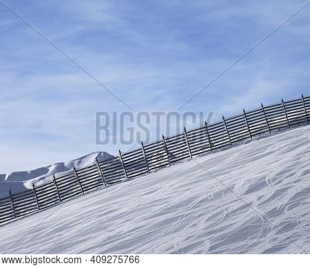 Snowy Ski Track Prepared By Snowcat With Trace From Skis And Snowboards. High Mountains At Sunny Win
