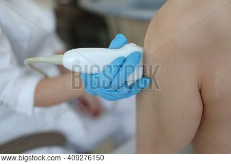 Doctor Doing Ultrasound Examination Of Knee Joint Closeup. Diagnosis And Treatment Of Arthritis Conc