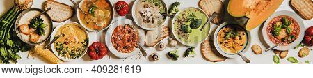 Flat-lay Of Creamy Homemade Soup In Plates With Bread Slices Over White Plain Table Background, Top 