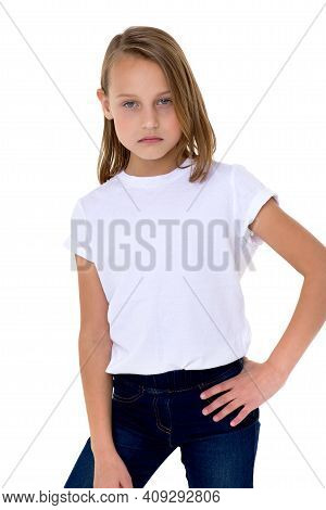 Blonde In A White T-shirt. Pretty Stylish Girl Posing In Studio On A White Background. Close-up Port