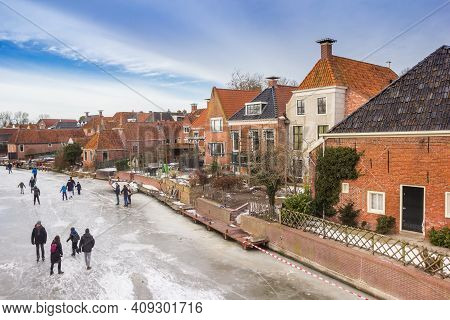 Winsum, Netherlands - February 14, 2021: People On The Ice In Winter In Winsum, Netherlands