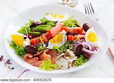 Ketogenic Diet Breakfast. Salt Salmon And Baked Dorado Salad With Greens, Tomatoes, Eggs And Avocado
