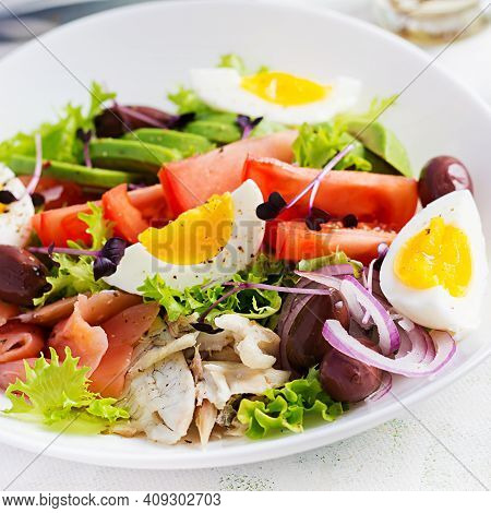 Ketogenic Diet Breakfast. Salt Salmon And Baked Dorado Salad With Greens, Tomatoes, Eggs And Avocado