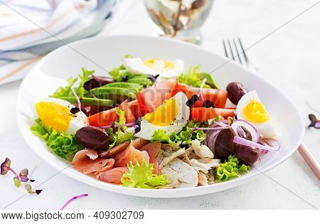 Ketogenic Diet Breakfast. Salt Salmon And Baked Dorado Salad With Greens, Tomatoes, Eggs And Avocado