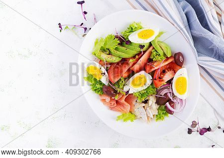 Ketogenic Diet Breakfast. Salt Salmon And Baked Dorado Salad With Greens, Tomatoes, Eggs And Avocado
