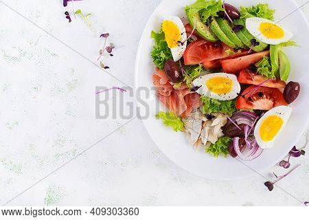 Ketogenic Diet Breakfast. Salt Salmon And Baked Dorado Salad With Greens, Tomatoes, Eggs And Avocado