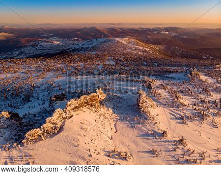 Colorful Winter Sunset In Sheregesh Ski Resort Mountains With Clouds. Aerial Top View Forest Russia