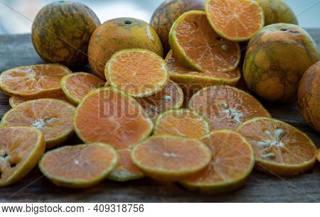 Close-up Of Fresh Orange Fruits On The Old Wooden Table. Tangerine Phurua Species, Juicy Orange Sour