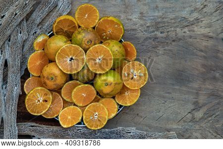 Fresh Orange Fruits On The Old Wooden Table. Tangerine Phurua Species, Juicy Orange Sour And Sweet, 