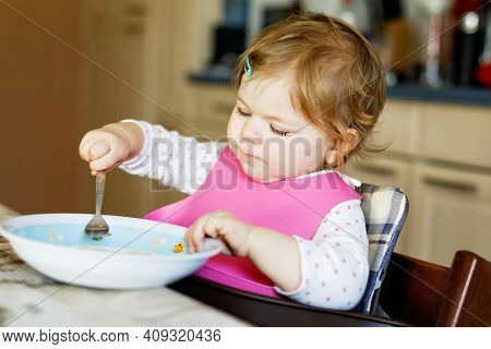 Adorable Baby Girl Eating From Spoon Mashed Vegetables And Puree. Food, Child, Feeding And People Co
