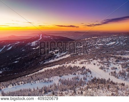 Colorful Winter Sunset In Sheregesh Ski Resort Mountains With Clouds. Aerial Top View Forest Russia