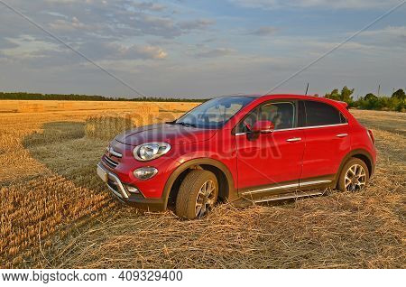 Ukraine, Novomoskovsk 07/24/2020. Beautiful, Modern Crossover Fiat 500x, In A Harvested Wheat Field.