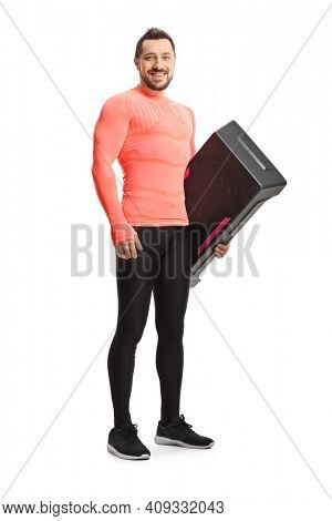Full length portrait of a man hlding a step aerobic platform isolataed on white background
