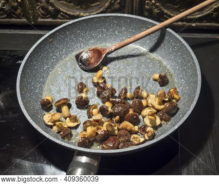 Fried Small Whole Wild Boletus Mushrooms. Cooking Forest Boletus In A Pan On A Hot Hotplate Stired W