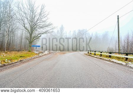 Road Crossing With Sign Showing The Way To Hallabrottet 2 Kilometers