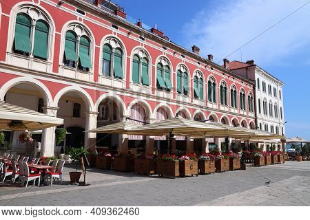 Split, Croatia - July 20, 2019: People Visit Shaded Arcades Of Prokurative Building In Split. Croati