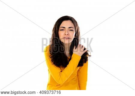 Adorable teenage girl with yellow sweater isolated on a white background
