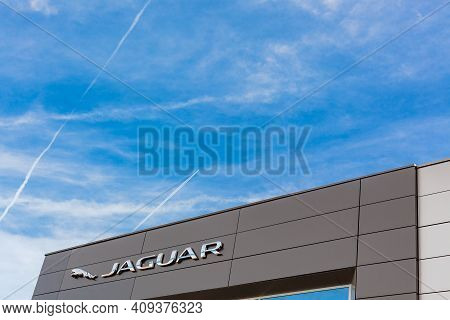 Jaguar Brand Logo On Bright Blue Sky Background Located On Its Dealer Office Building In Lyon, Franc