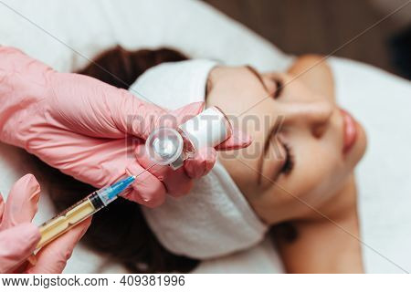 The Doctor Gives An Injection Into The Woman's Cheekbone. Cosmetology Close-up