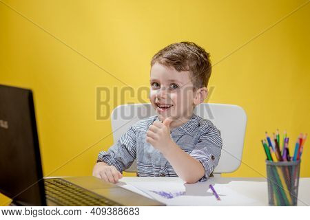 Distance Learning Online Education. A Schoolboy Boy Studies At Home And Does School Homework. A Home