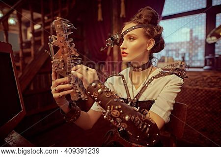 Steampank fantasy world. Beautiful steampunk lady scientist inventor works in her laboratory with Victorian interior. 