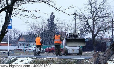Maikop, Republic Of Adygea, Russia - January 16, 2021: Mini Loader With Raised Bucket And A Pair Of 