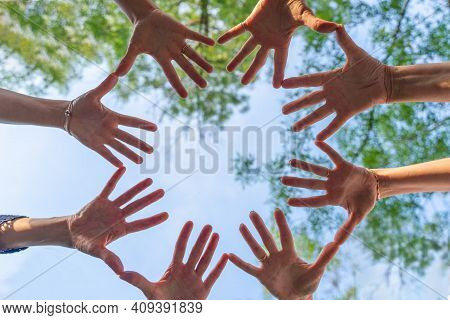 Team Stacks Hands In A Workshop For Teambuilding And Teambuilding.