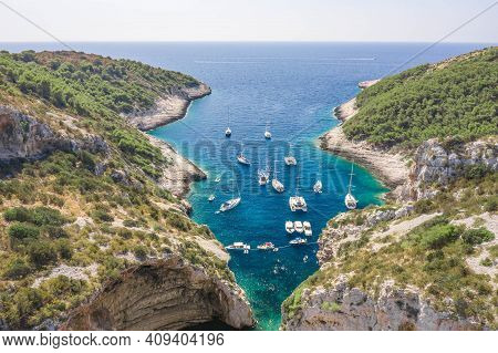 Aerial Shot Of Yachts Boats At Stiniva Cove Beach Of Adriatic Sea On Vis Island In Croatia Summer