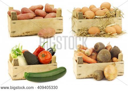 Freshly harvested cooking vegetables in wooden crate on a white background
