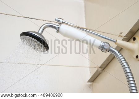 Water Flowing From An Old Shower Head With Ceramic Handle With Limescale Needed To Be Replaced Or De