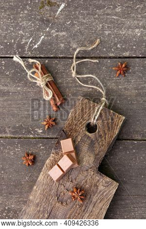 Pieces Of Chocolate, Cinnamon Sticks And Star Anise On A Wooden Board, Photo Rusticstyle