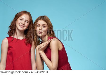 Mom And Daughter In Red Dresses Entertainment Lifestyle Fun Studio Blue Background