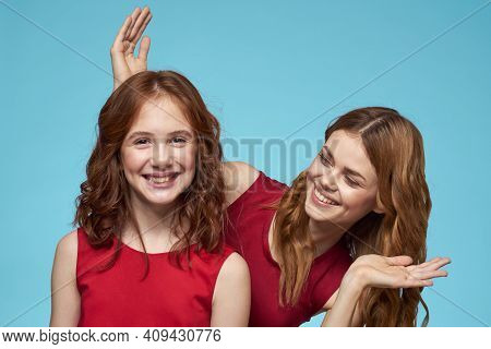 Family Mom And Daughter Hug Red Dresses Communication Emotions Blue Background