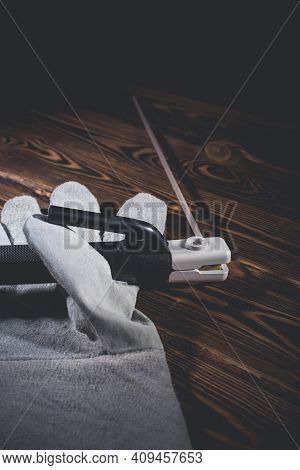 The Holder Of The Welding Electrode With An Electrode, Lie In A Welding Glove On A Wooden Background
