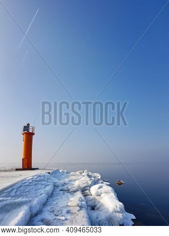 Navigation Red Lighthouse On Mangalsala Pier In Baltic Sea Located At Riga Sea Port, Latvia, Europe