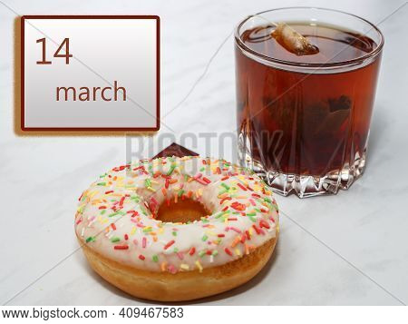 March 14 ,14th Day Of The Month. Calendar With Date And A Cupcake With Glass Of Tea On Table At Home
