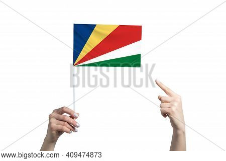 A Beautiful Female Hand Holds A Seychelles Flag To Which She Shows The Finger Of Her Other Hand, Iso