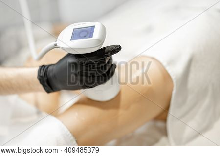 Doctor Doing Ultrasound Liposuction Procedure In Medical Clinic.
