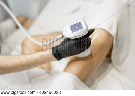 Doctor Doing Ultrasound Liposuction Procedure In Medical Clinic.