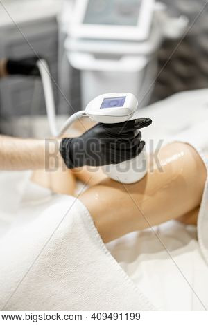 Doctor Doing Ultrasound Liposuction Procedure In Medical Clinic.