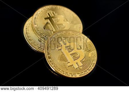 Gold Bitcoin Coins On Black Background. Three Gold Bitcoin Coins. Bitcoin Close Up. Golden Bitcoins.