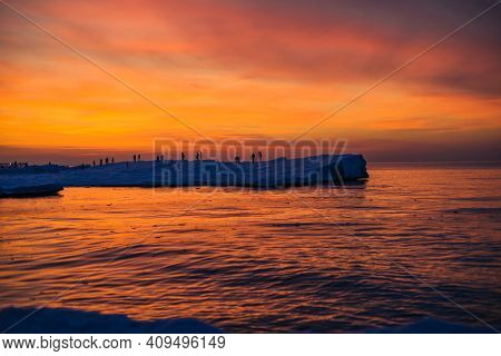 Blocks Of Ice On The Seashore At Sunset At A Frosen Baltic Sea