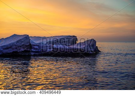 Blocks of ice on the seashore at sunset at a frosen Baltic sea