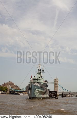 Portrait Of Hms Belfast Moored On The River Thames In London