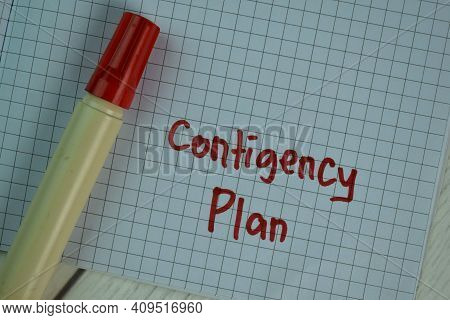 Contigency Plan Write On A Book Isolated On Wooden Table.