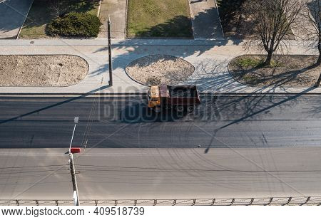 Truck With A Breakstone On A Road In The City During Road Construction Work.