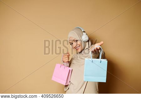 Adorable Arabic Muslim Woman In Hijab With A Beautiful Toothy Smile Stands Sideways To The Camera An