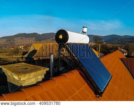 Solar Water Heater Boiler On Rooftop Close Up Aerial Drone View.