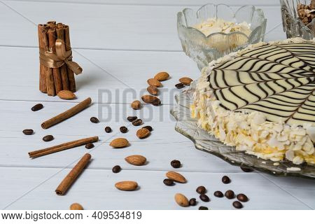 Delicious Esterhazy Cake, Cinnamon, Almonds, Coffee And Walnuts, On A Light Wooden Table, Copy Space
