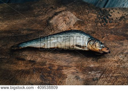 Dried Fish Lies On A Wooden Table Top View Texture Background Image